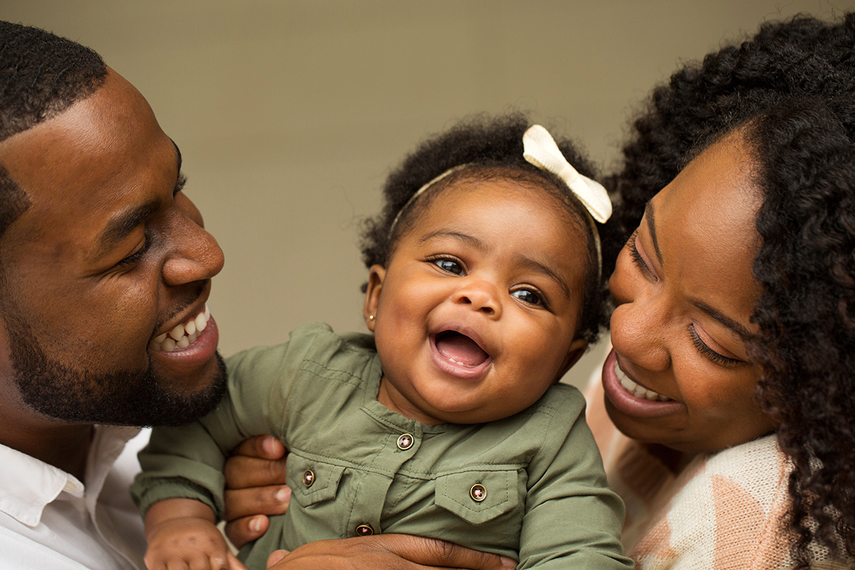Happy first-time parents with their baby